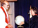 Bishop Tim Whitaker's receives a globe from conference missions ministry team